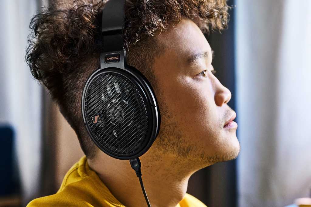 Model wearing Sennheiser HD 660S2 open-back headphone